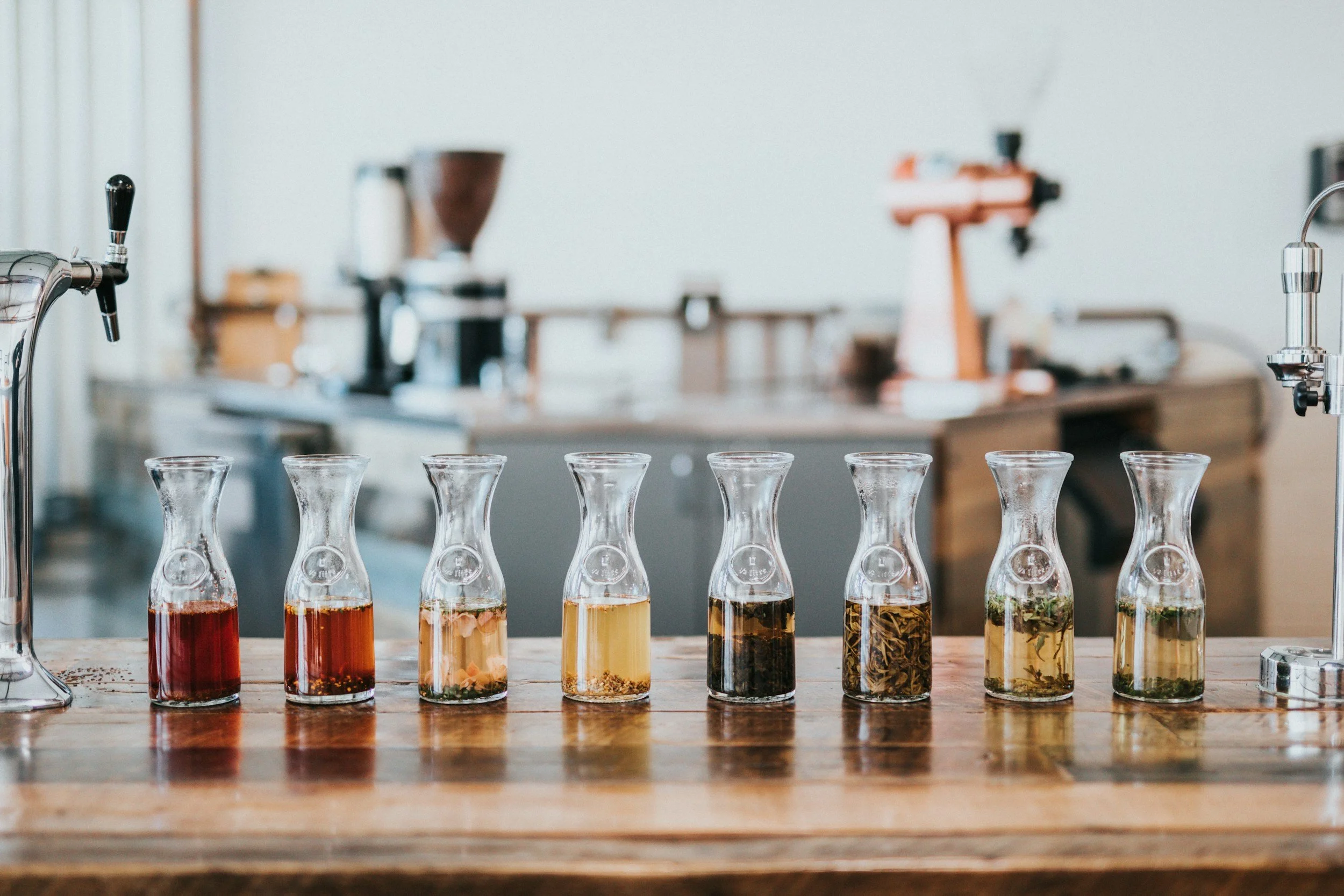 Row of carafes with olive oils and vinegars for a tasting pairing