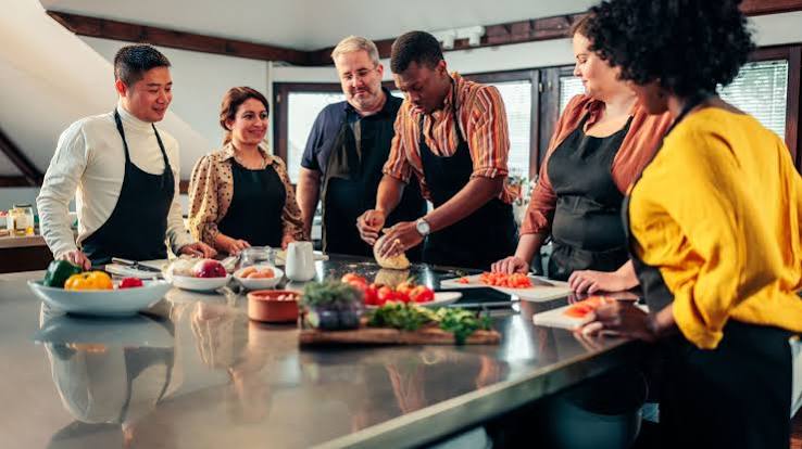 Diverse team cooking together at a wellness workshop