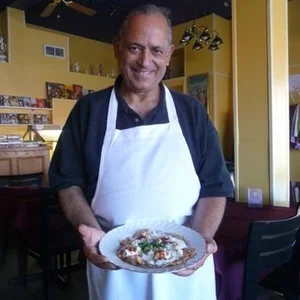Chef Teena's father cooking at Delights of India