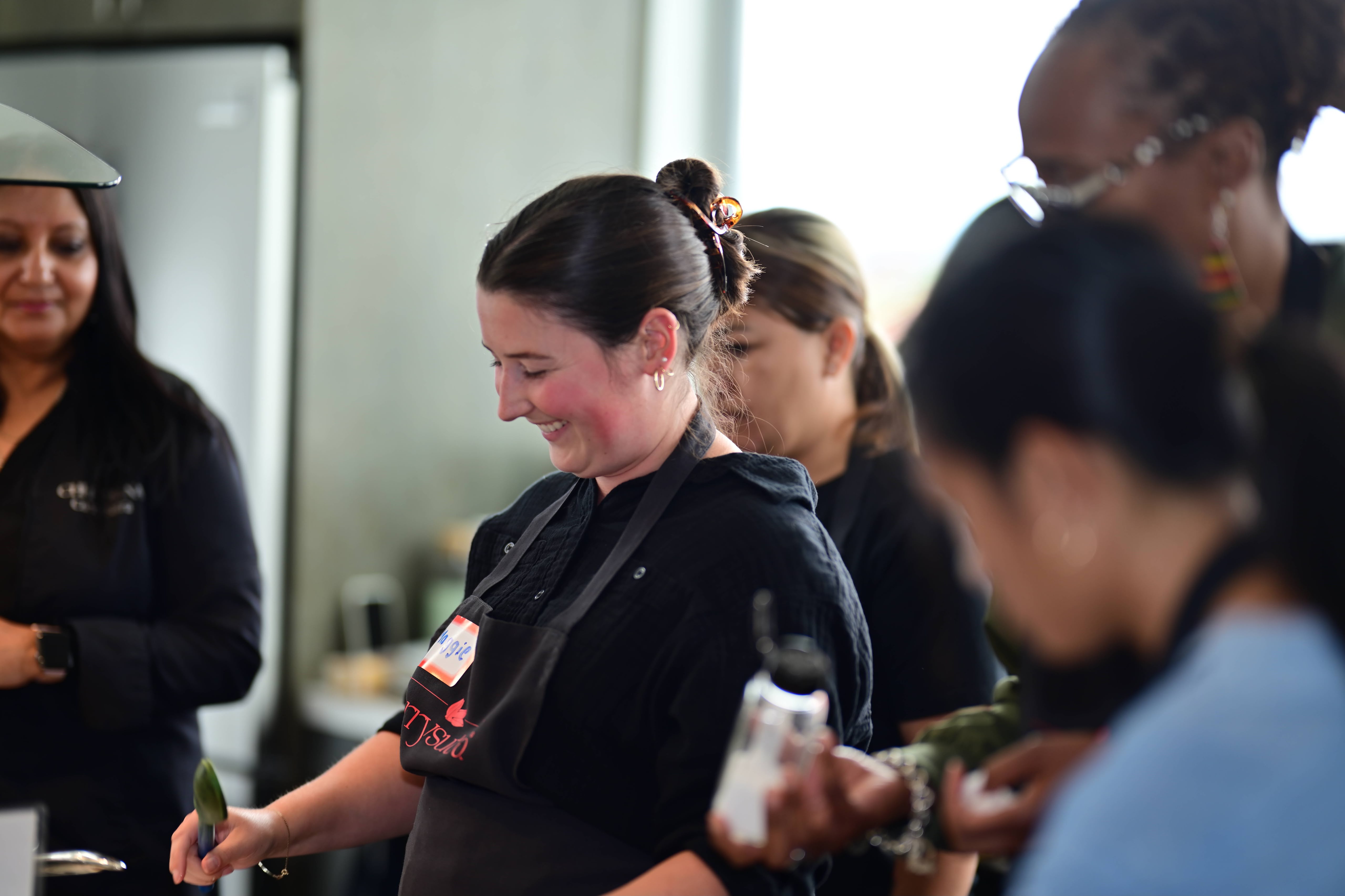 Team members laughing and working together during a hands-on culinary challenge