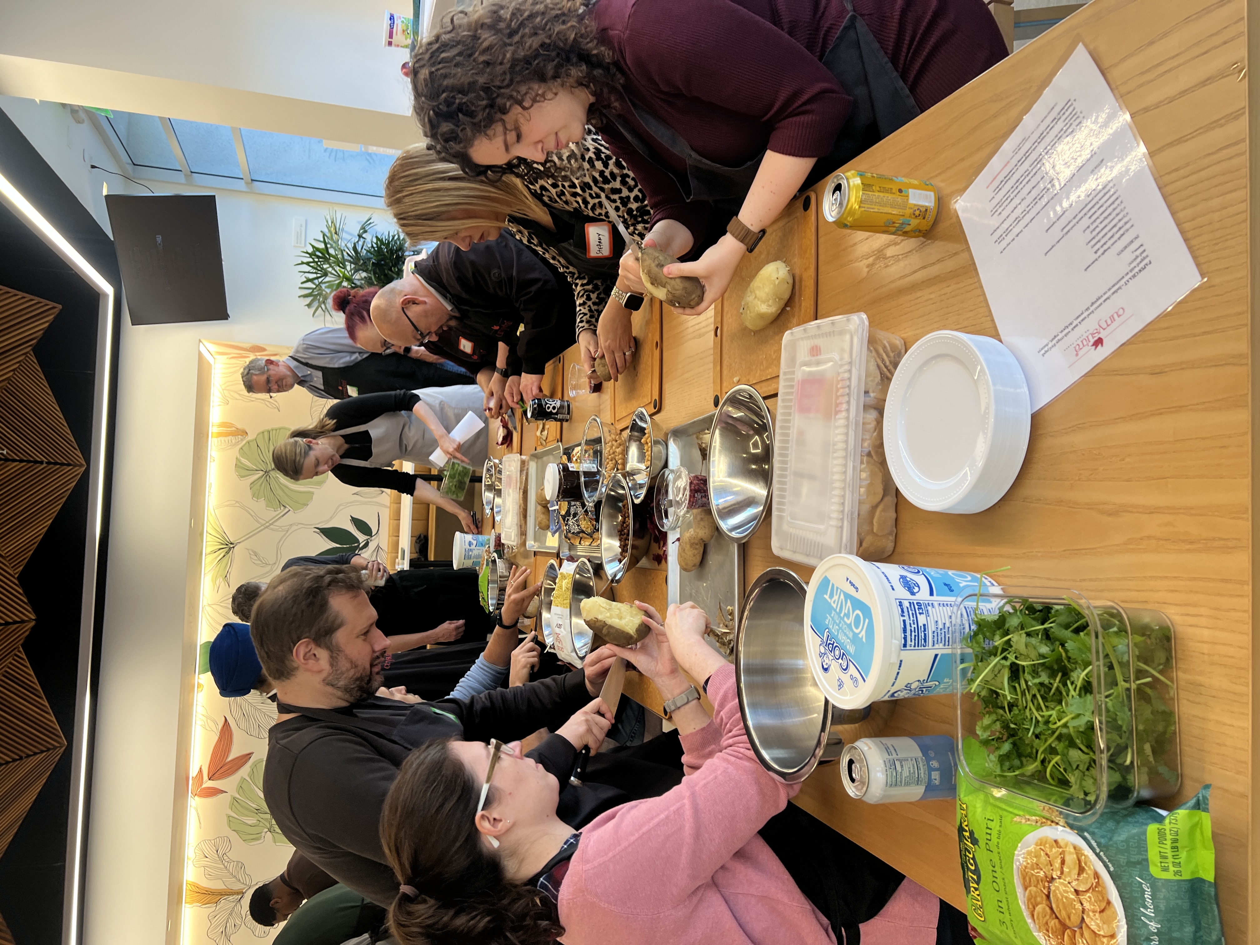 Teams prepping ingredients station-to-station for a cooking competition