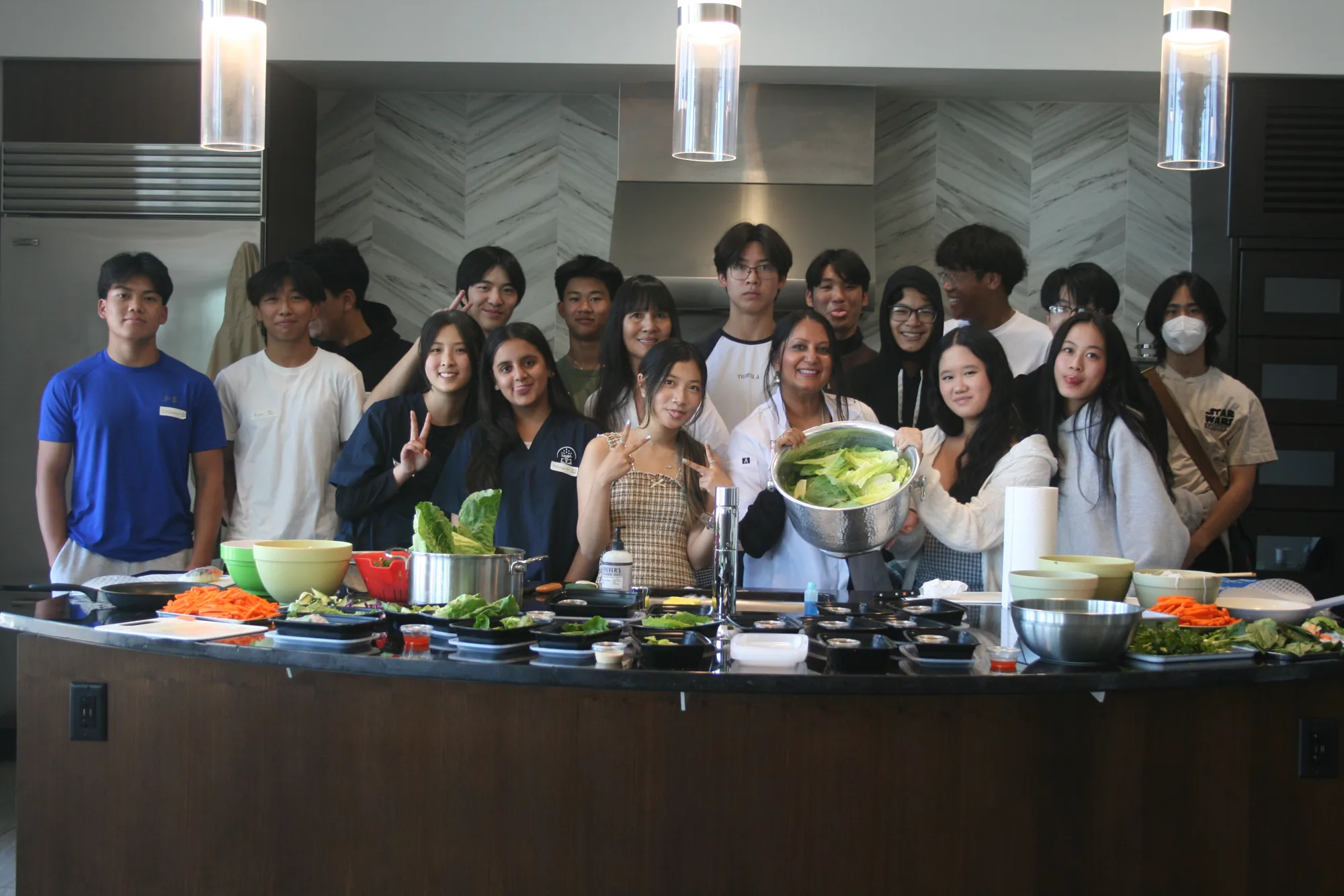 Group hands-on wellness cooking session with fresh greens and produce